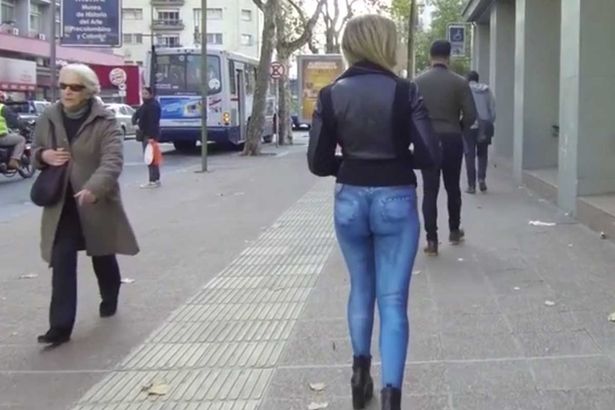 PAY Model struts around wearing nothing but G string and painted on jeans