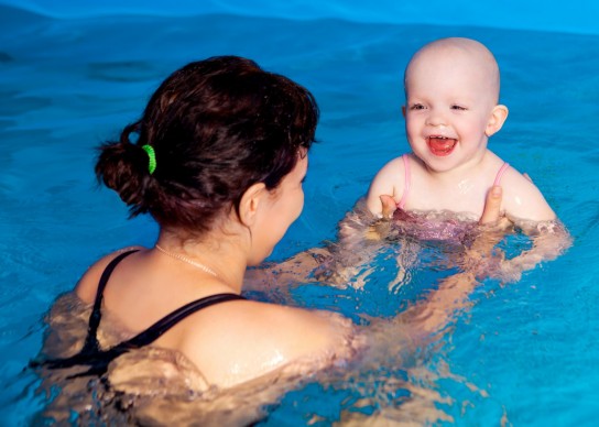 bigstock mother teaching her baby swimm 49642274508