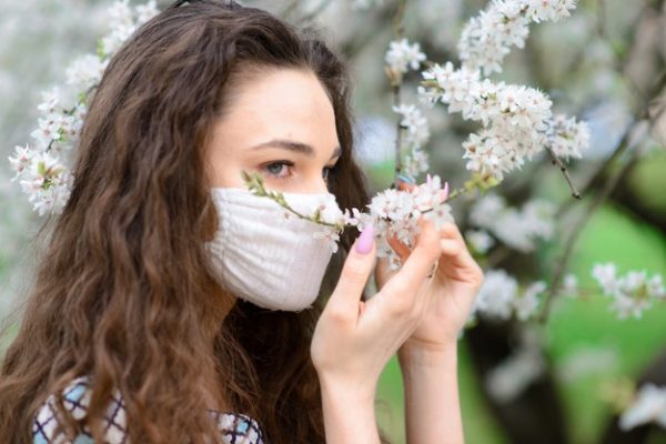 close up portrait of tender female under a blossoming tree with a mask 229518 1986 600x400