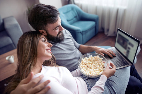 depositphotos 203262480 stock photo happy young couple sitting sofa