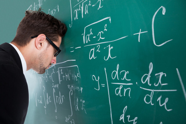 leaning head on blackboard