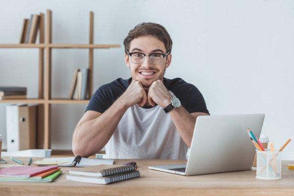 student sitting table notebooks