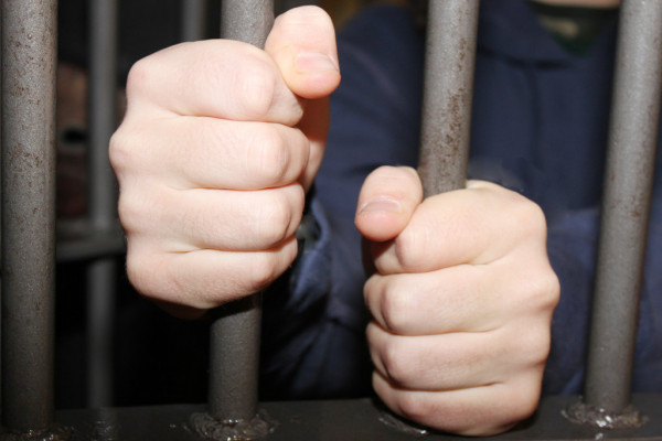 depositphotos 11234294 stock photo man behind bars