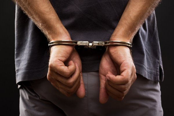 depositphotos 28098513 stock photo close up arrested man handcuffed