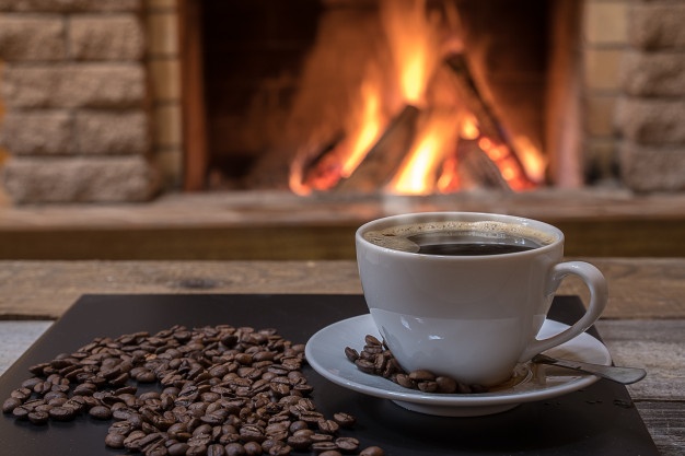 cozy fireplace and a cup of coffee coffee beans in country house winter vacation 73966 1847