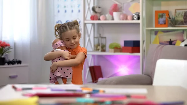 girl holding doll hugging favorite